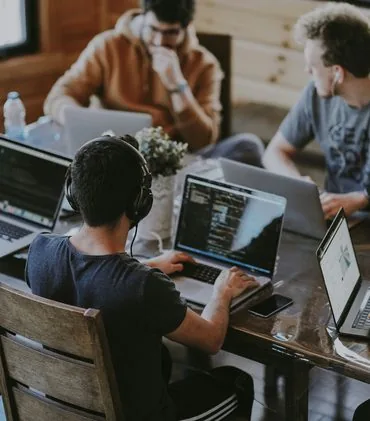 Group of coworkers using a laptop together