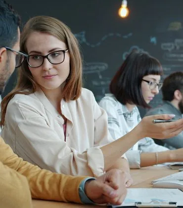 Colleagues collaborating at a modern office desk