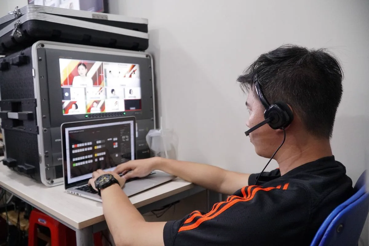 Broadcast technician monitoring a multi-camera streaming setup