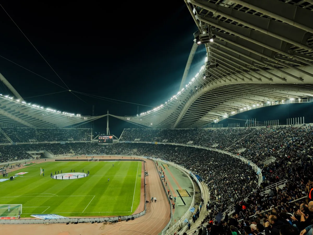 Illuminated stadium packed with fans during a night match