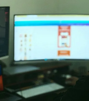 Person working on a computer with multiple monitors