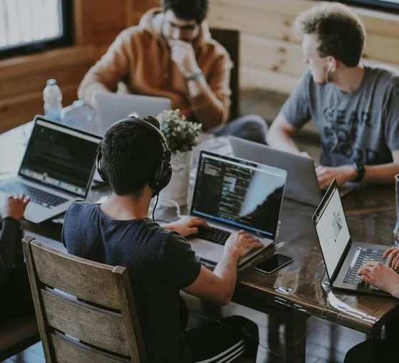 IT support team working together on laptops in the office