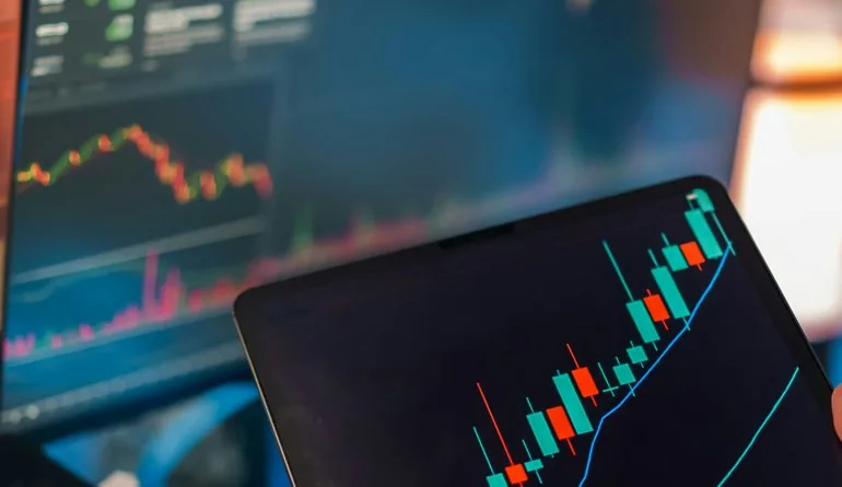 Trading and analytics charts displayed on multiple screens