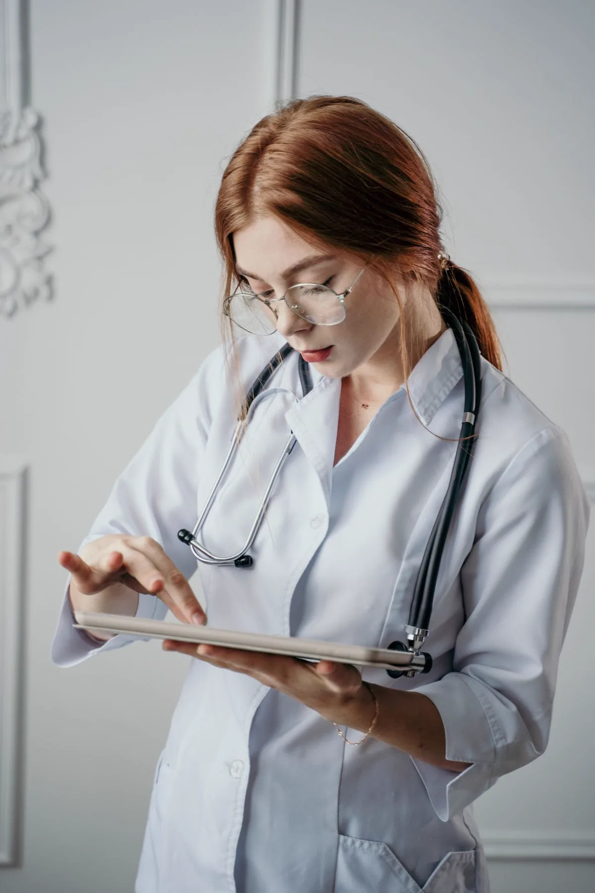 Clinician reviewing a patient record on a tablet